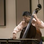 Harana Music Academy teacher playing double bass.